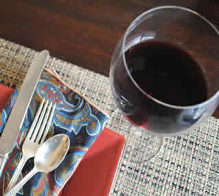 glass of red wine with table setting